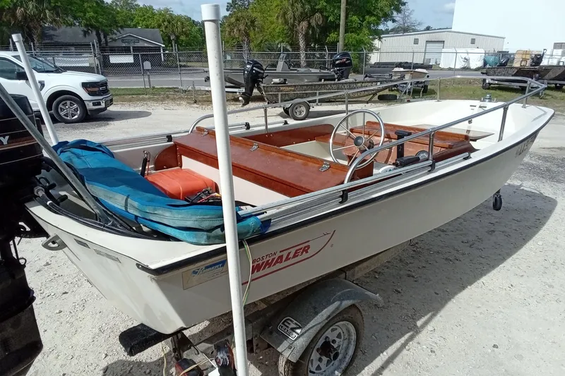 Slide: The Image of 1985 Boston Whaler 13 Sport boat on trailer, parked outdoors. - 7