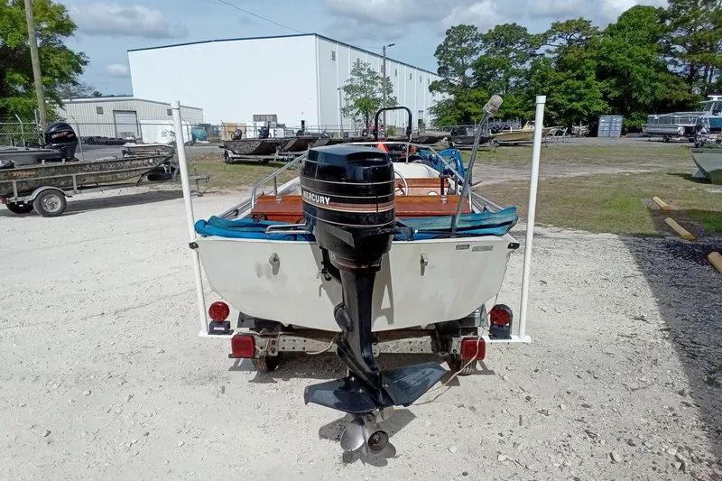 Slide: The Image of 1985 Boston Whaler 13 Sport boat with Mercury outboard motor on a trailer. - 8