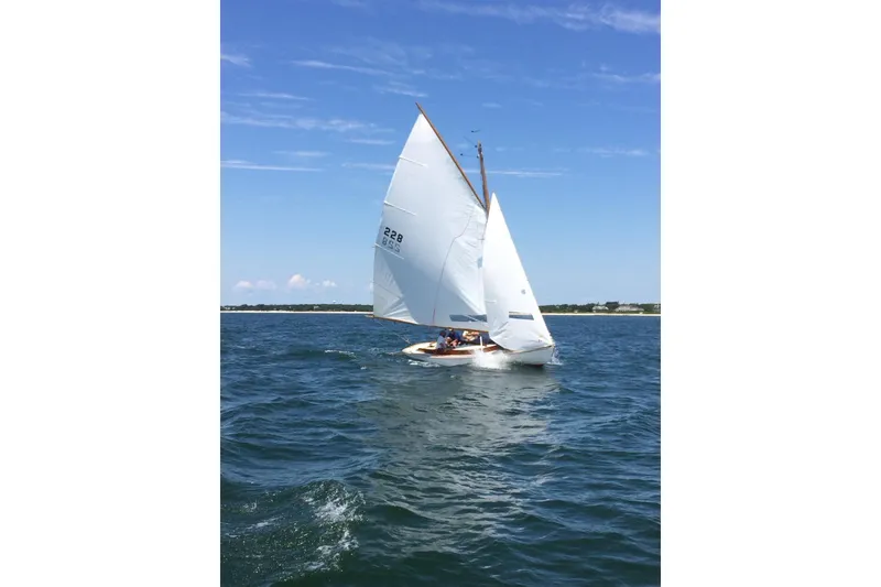 Slide: The Image of Sailing on a 2020 Wianno Senior boat under clear blue skies. - 2