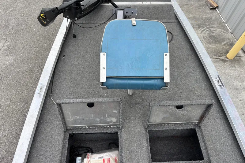 Slide: The Image of 1991 Bass Tracker Tournament TX-17 boat interior with blue seat and storage compartments. - 4