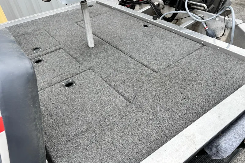 Slide: The Image of 1991 Bass Tracker Tournament TX-17 boat deck with carpeted surface and storage compartments. - 7