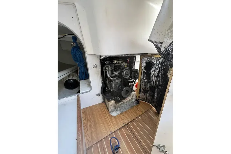 Slide: The Image of Engine compartment of a 2001 J Boats J/105 sailboat, featuring visible engine components. - 11