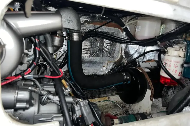 Slide: The Image of Engine compartment of a 2001 J Boats J/105, showcasing mechanical components and wiring. - 13