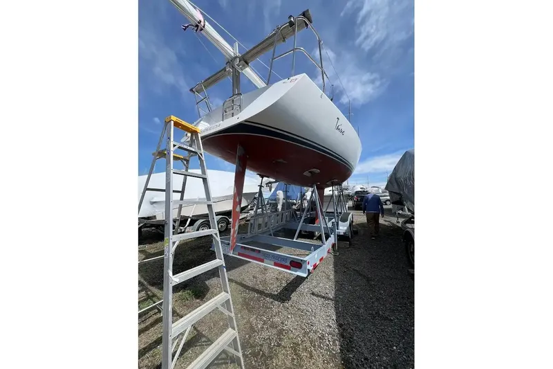 Slide: The Image of 2001 J Boats J/105 sailboat on trailer, viewed from below, with ladder and clear sky. - 16