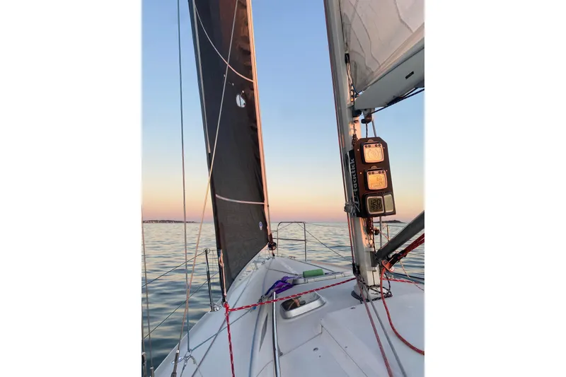 Slide: The Image of Sailing on a 2001 J Boats J/105 at sunset, showcasing sails and calm waters. - 3