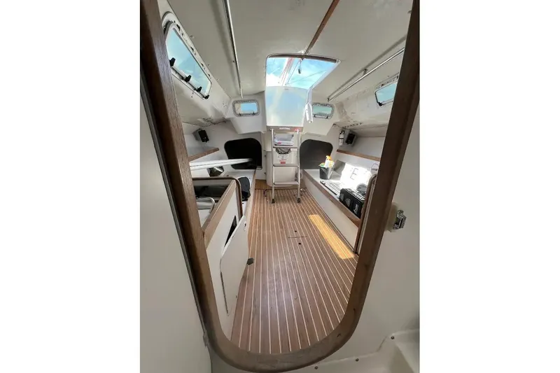 Slide: The Image of Interior view of 2001 J Boats J/105 sailboat, featuring sleek design and wooden flooring. - 7