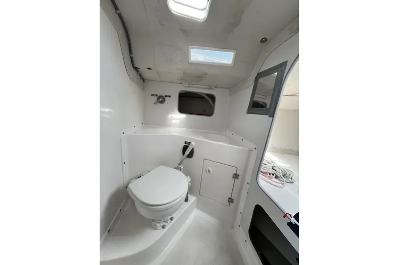 Slide: The Image of Interior of 2001 J Boats J/105 sailboat, featuring a compact marine toilet setup. - 8