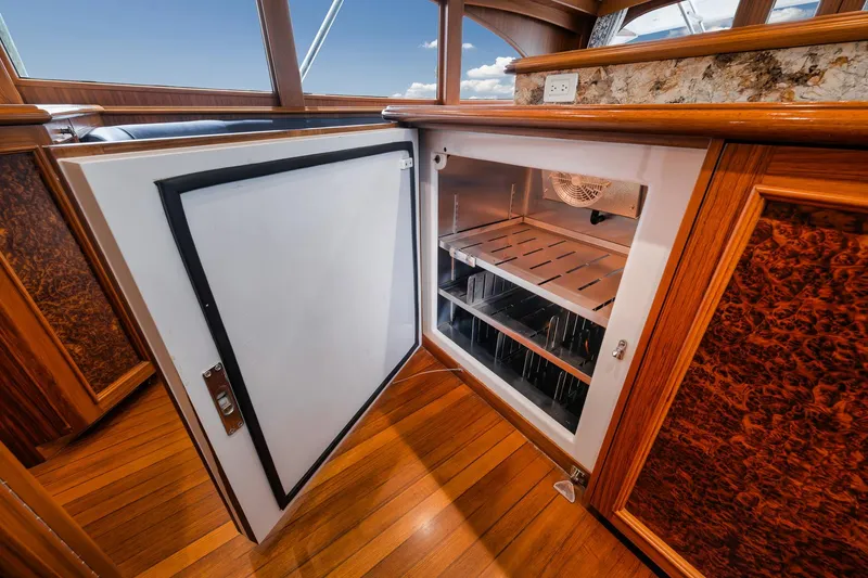 Slide: The Image of Open refrigerator on 2011 Jim Smith Custom Sportfish yacht with wooden interior detailing. - 31