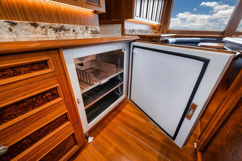 Slide: The Image of Luxurious wooden interior of 2011 Jim Smith Custom Sportfish with open refrigerator. - 32