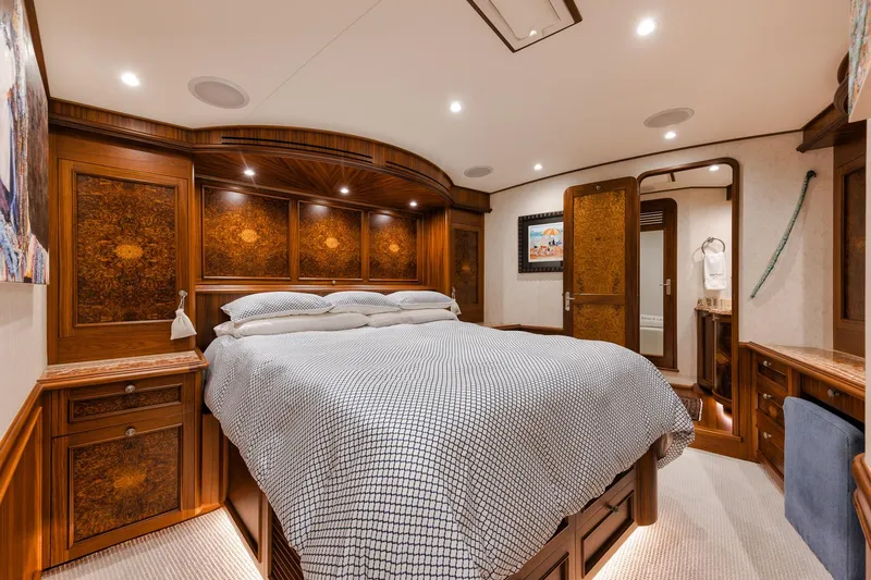 Slide: The Image of Luxurious bedroom interior on 2011 Jim Smith Custom Sportfish yacht, featuring elegant woodwork and cozy bedding. - 48
