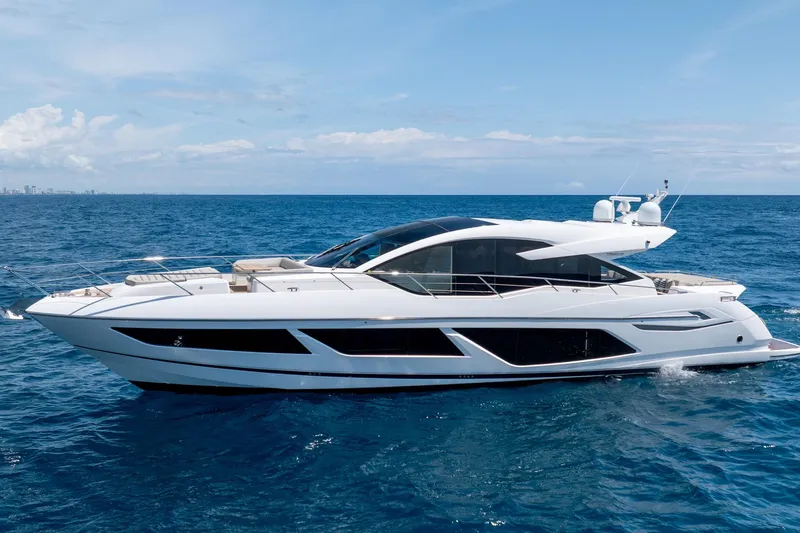 Slide: The Image of 2020 Sunseeker Predator 74 XPS yacht cruising on open sea under clear sky. - 1