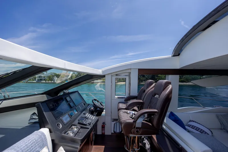 Slide: The Image of Luxurious 2020 Sunseeker Predator 74 XPS yacht cockpit with leather seats and modern controls. - 101