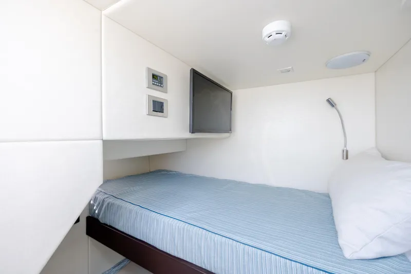 Slide: The Image of Compact cabin interior of 2020 Sunseeker Predator 74 XPS yacht with bed and control panel. - 14
