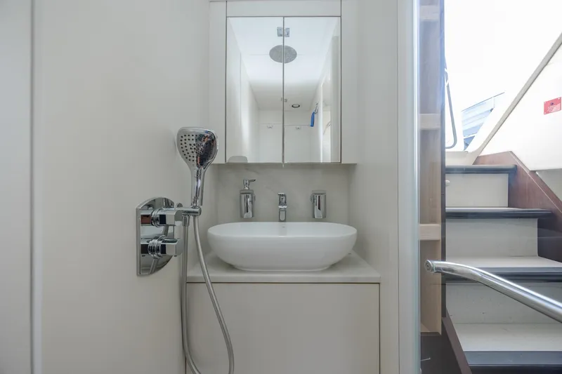 Slide: The Image of Modern bathroom on 2020 Sunseeker Predator 74 XPS yacht, featuring sleek fixtures and mirror. - 16