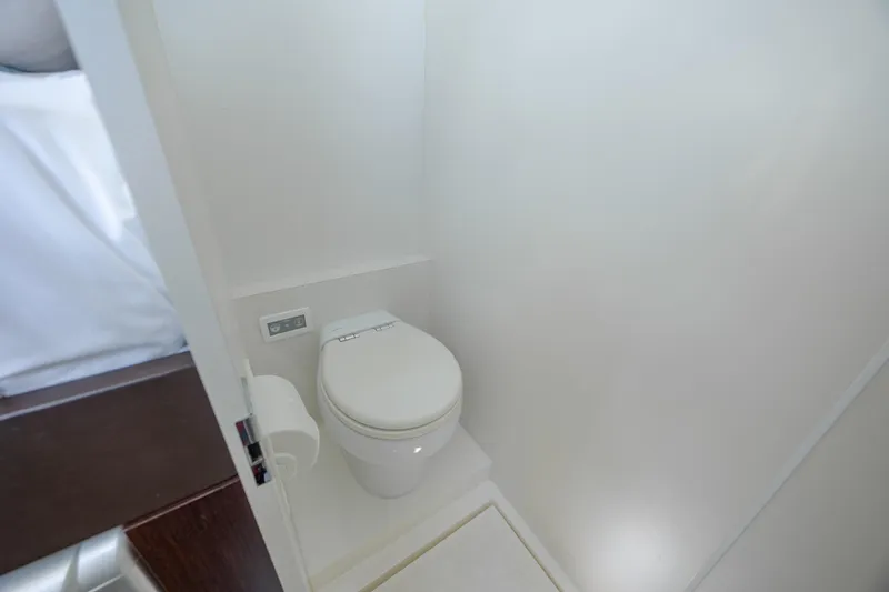 Slide: The Image of Modern bathroom on 2020 Sunseeker Predator 74 XPS yacht, featuring sleek white toilet design. - 17