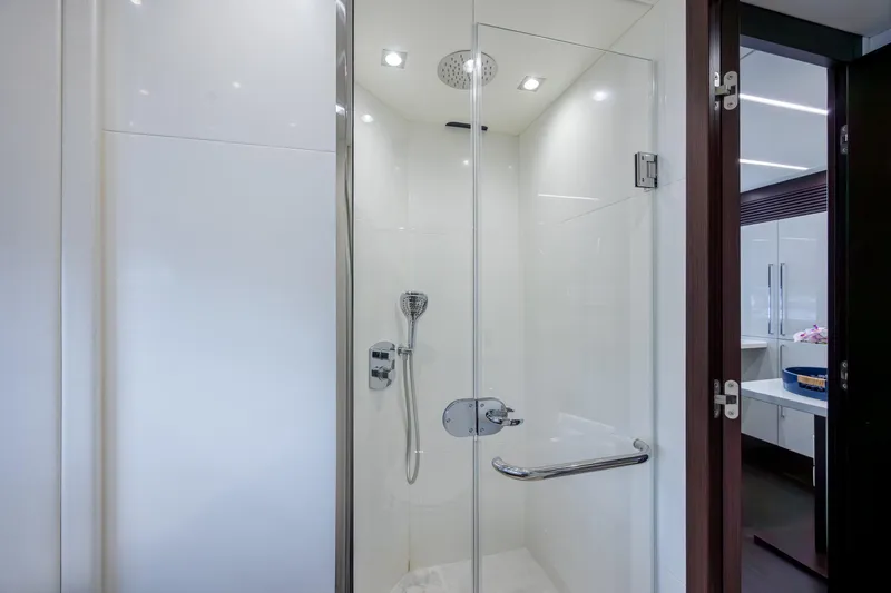 Slide: The Image of Luxurious shower in 2020 Sunseeker Predator 74 XPS yacht, featuring sleek glass doors and modern fixtures. - 51