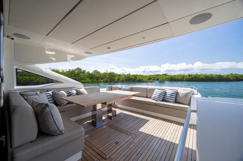 Slide: The Image of Luxurious Sunseeker Predator 74 XPS yacht deck with elegant seating and scenic water view. - 64