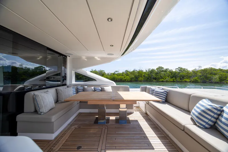 Slide: The Image of Luxurious Sunseeker Predator 74 XPS yacht deck with elegant seating and scenic water view. - 65