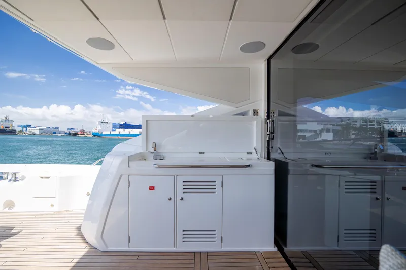 Slide: The Image of Sunseeker Predator 74 XPS 2020 yacht deck with outdoor kitchenette and ocean view. - 70