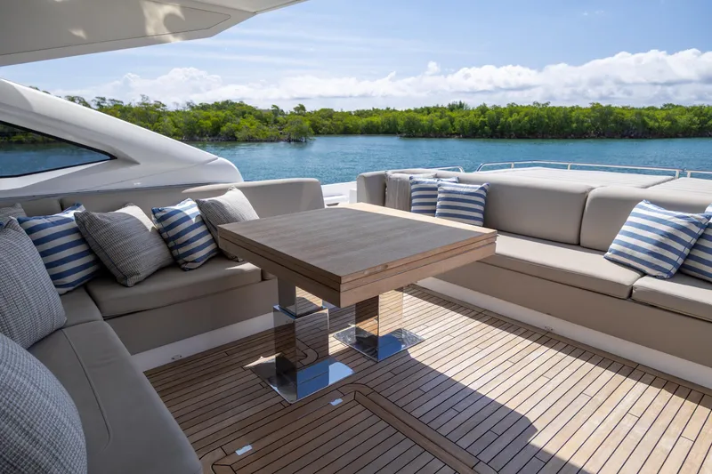 Slide: The Image of Luxurious Sunseeker Predator 74 XPS yacht deck with elegant seating and scenic water view. - 74
