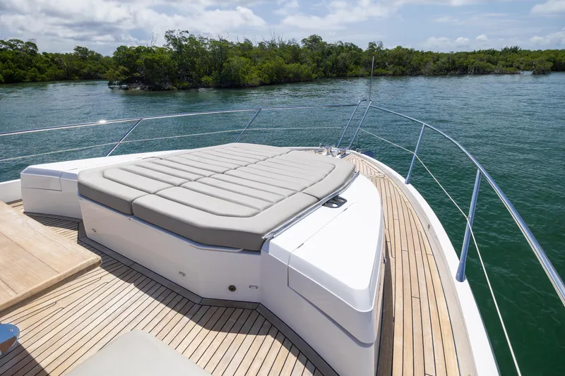 Slide: The Image of Luxury Sunseeker Predator 74 XPS yacht deck with sunbed, 2020 model, on serene water. - 92