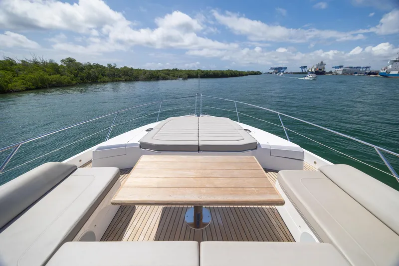 Slide: The Image of Sunseeker Predator 74 XPS 2020 yacht deck with seating and table, cruising on a sunny day. - 97