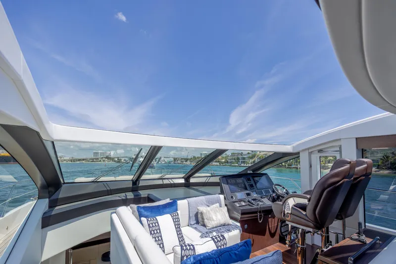 Slide: The Image of Luxurious Sunseeker Predator 74 XPS yacht interior with plush seating and advanced helm controls. - 99