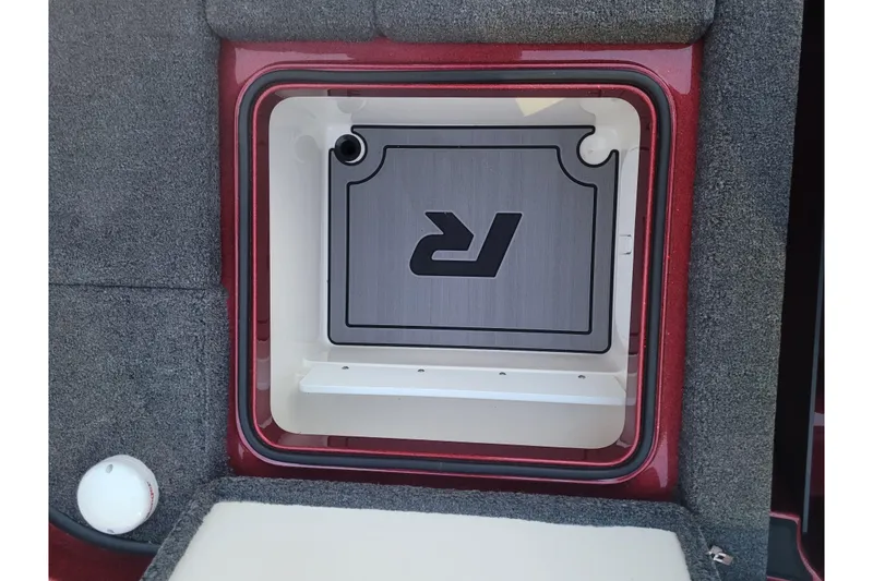 Slide: The Image of 2024 Ranger Z520R Cup-Equipped storage compartment with logo, featuring carpeted interior. - 11