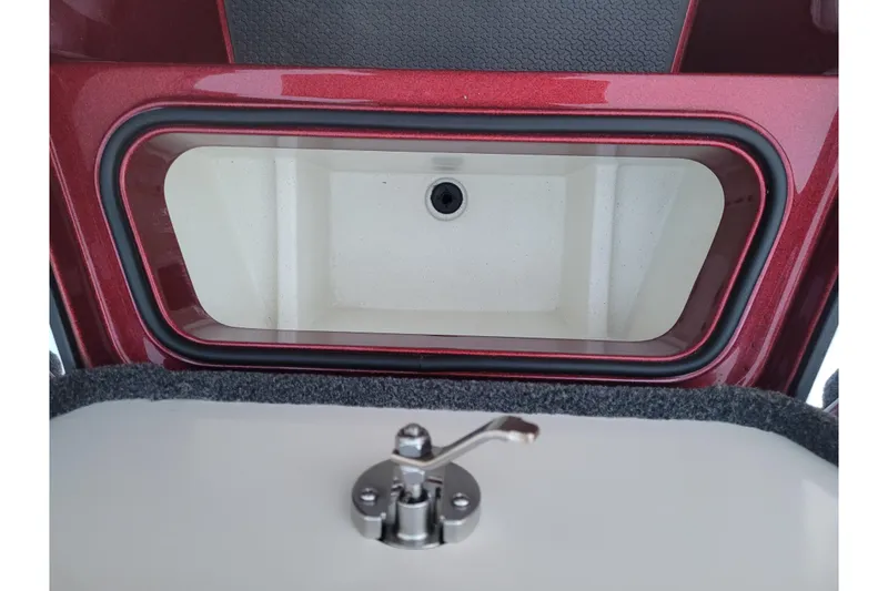 Slide: The Image of 2024 Ranger Z520R Cup-Equipped storage compartment with red trim and secure latch. - 17