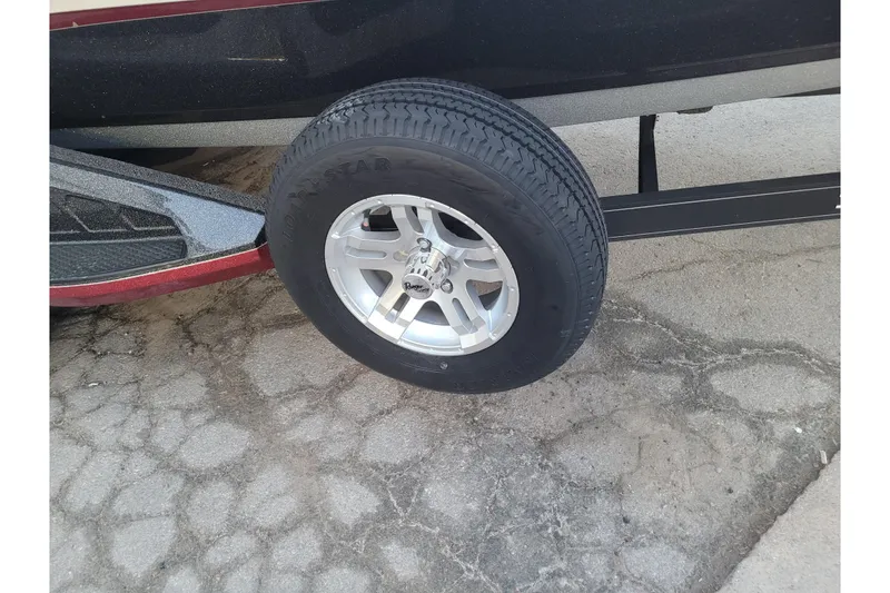 Slide: The Image of 2024 Ranger Z520R Cup-Equipped trailer wheel on cracked pavement. - 25