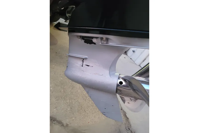 Slide: The Image of 2024 Ranger Z520R Cup-Equipped boat motor with visible wear and damage. - 4