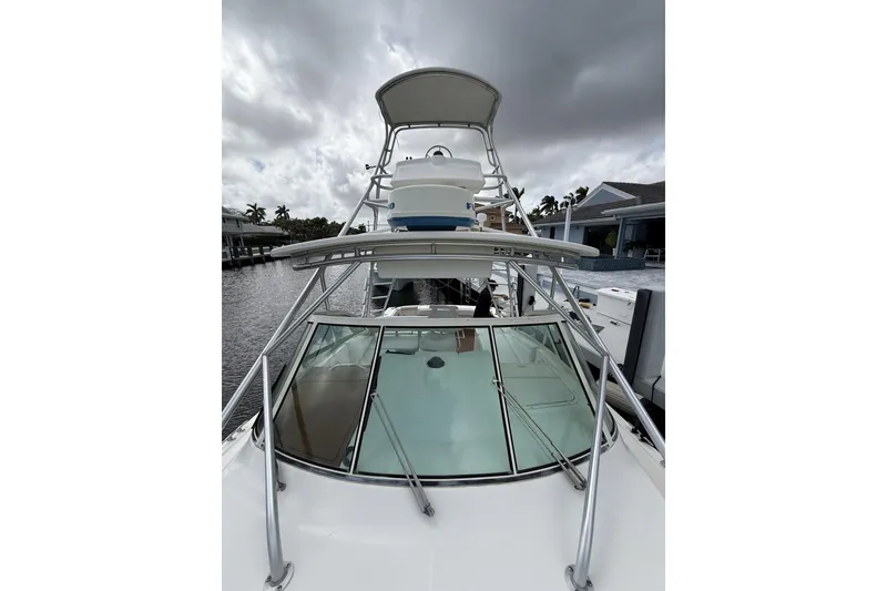 Slide: The Image of 2005 Albemarle 30 Express boat with tower, docked under cloudy skies. - 10
