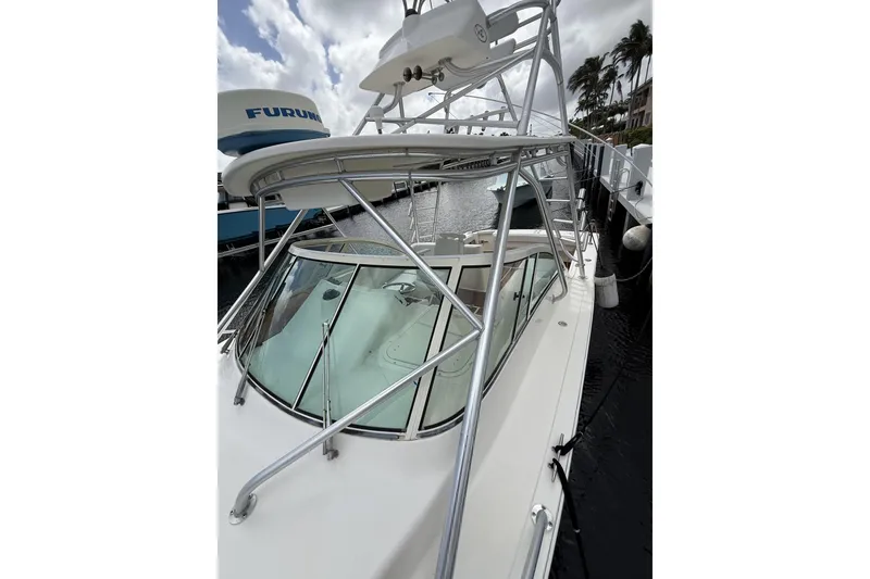 Slide: The Image of 2005 Albemarle 30 Express boat docked, featuring sleek design and sturdy structure. - 13