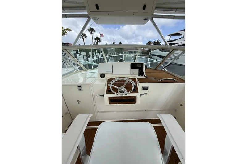 Slide: The Image of 2005 Albemarle 30 Express boat helm with steering wheel and navigation equipment. - 15