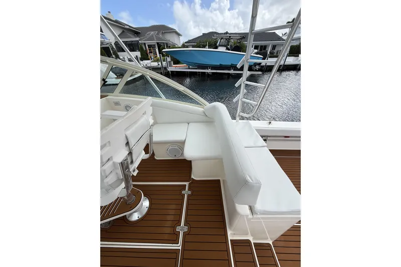 Slide: The Image of 2005 Albemarle 30 Express boat interior with white seating and wooden deck. - 19