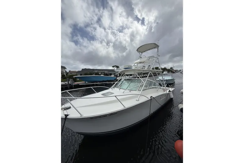 Slide: The Image of 2005 Albemarle 30 Express boat docked under cloudy skies. - 2