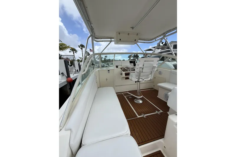 Slide: The Image of 2005 Albemarle 30 Express boat interior with white seating and wooden flooring. - 20