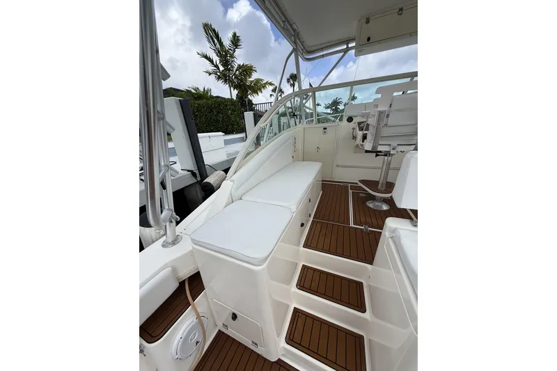 Slide: The Image of 2005 Albemarle 30 Express boat interior with cushioned seating and wooden flooring. - 21