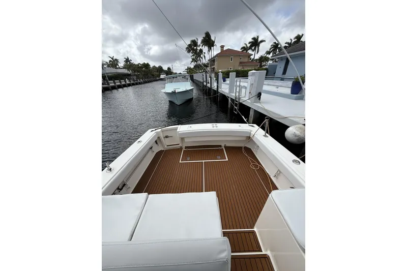 Slide: The Image of 2005 Albemarle 30 Express boat docked, featuring spacious deck and sleek design. - 22
