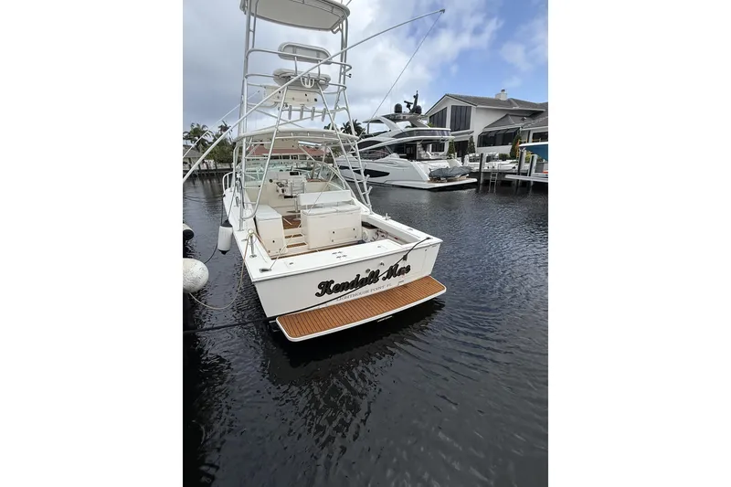 Slide: The Image of 2005 Albemarle 30 Express boat docked at marina, rear view. - 3