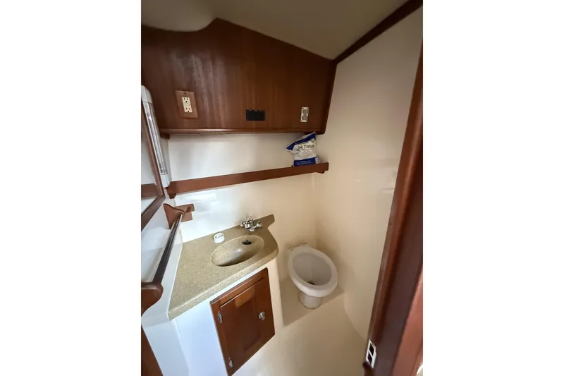 Slide: The Image of Compact bathroom in 2005 Albemarle 30 Express boat with sink and toilet. - 30