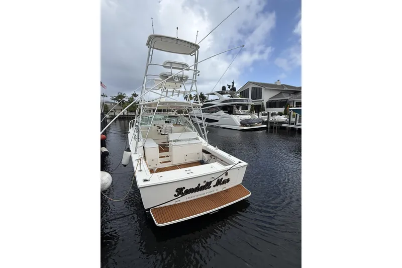 Slide: The Image of 2005 Albemarle 30 Express boat docked in a marina, featuring a spacious deck and tower. - 6