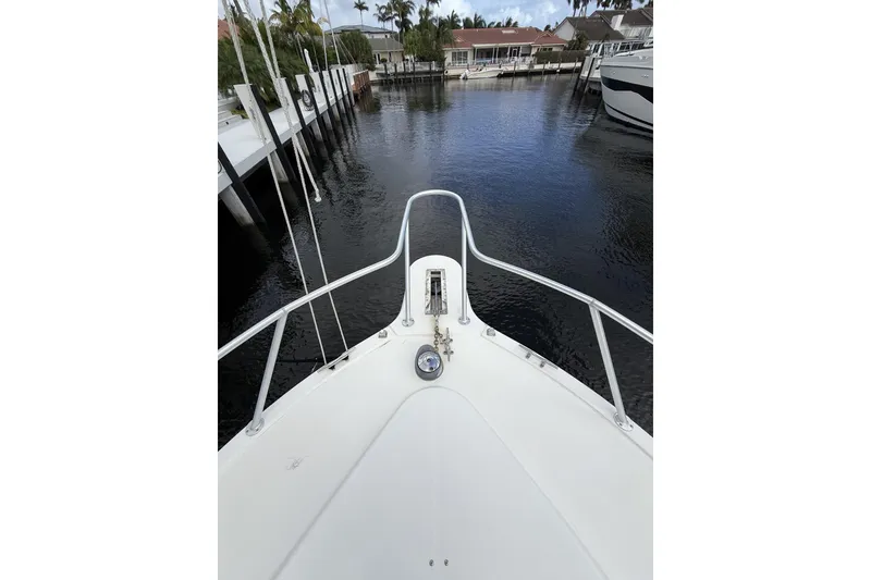 Slide: The Image of Bow view of 2005 Albemarle 30 Express boat docked in a serene marina. - 8