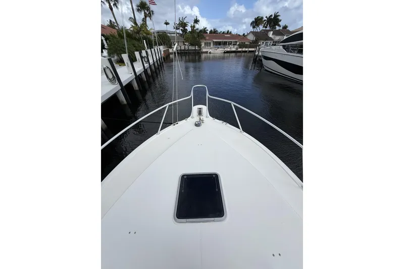 Slide: The Image of Bow view of 2005 Albemarle 30 Express docked in a serene marina. - 9
