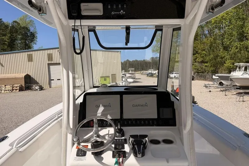 Slide: The Image of 2021 Sea Hunt Gamefish 27 helm with Garmin displays and steering wheel. - 7