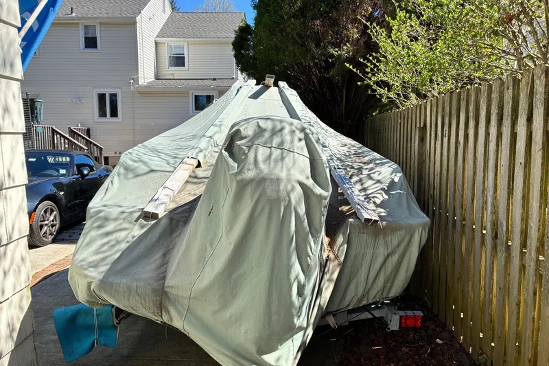 Slide: The Image of 2015 Boston Whaler 170 Montauk boat interior with cushioned seating and cooler. - 6