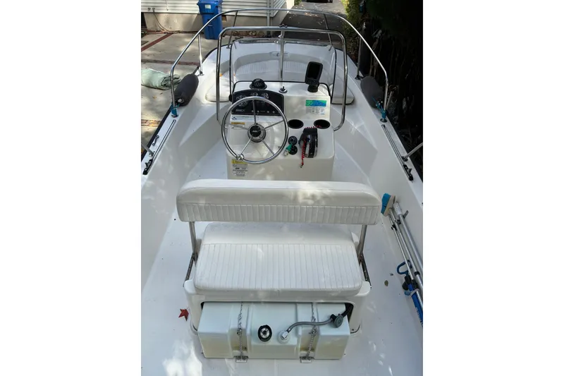 Slide: The Image of 2015 Boston Whaler 170 Montauk boat interior with steering wheel and seating. - 7