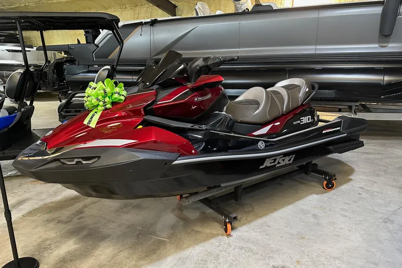 The Image of 2026 Kawasaki Jetski Ultra 310LX with green bow, displayed indoors. - 0