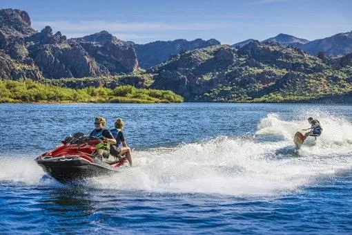 Slide: The Image of 2026 Kawasaki Jetski Ultra 310LX on scenic lake with mountains in background. - 3