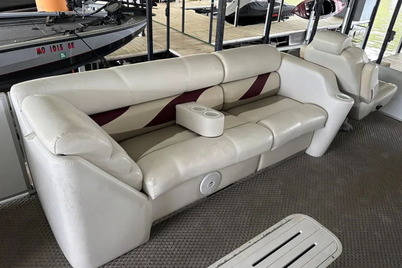 Slide: The Image of 2007 Crest 2570 III XRS boat interior with beige seating and cup holders. - 12